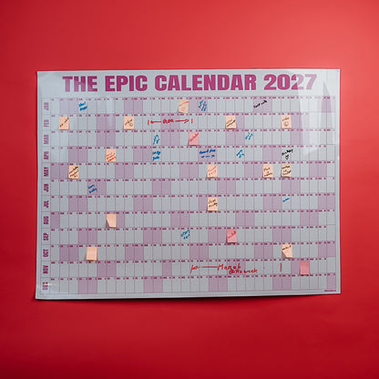 Rose EPIC Calendar 2027 with notes on a red wall